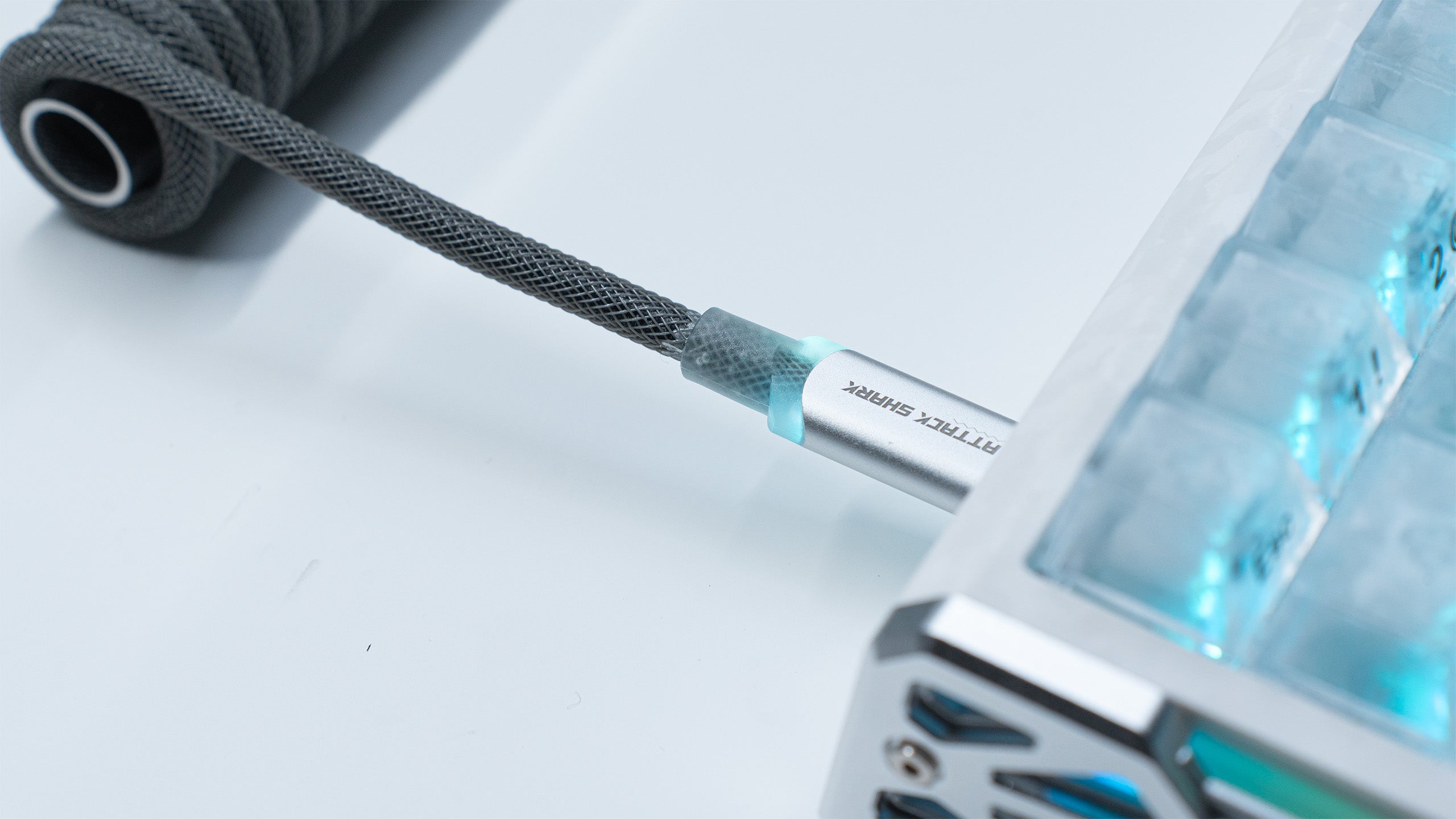 ATTACK SHARK C01ULTIMATE coiled USB-C cable with gray braided sleeve and glowing connector